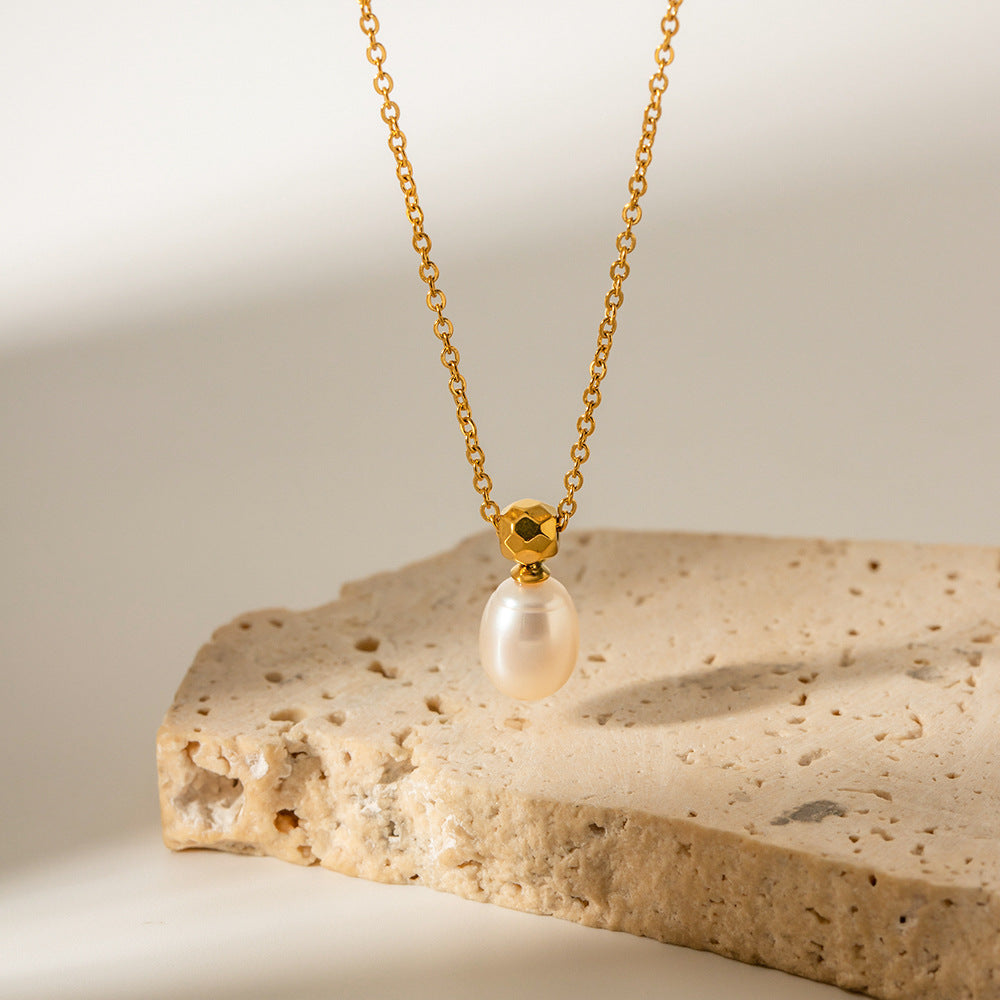 A Maramalive™ Personalized Simple Niche Cross Pearl Necklace For Women with a white pearl on top of a stone.