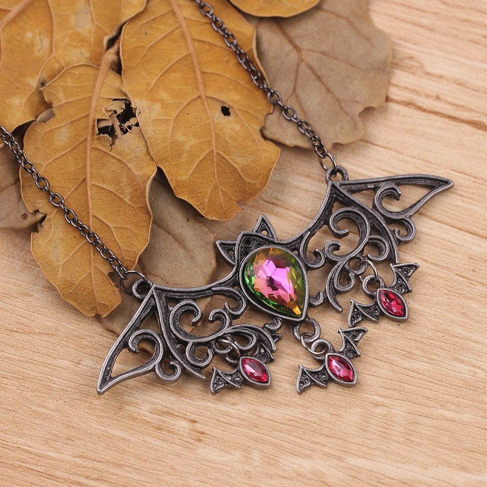 A Maramalive™ Halloween Accessories Vintage Bat Necklace with bats and pink crystals.
