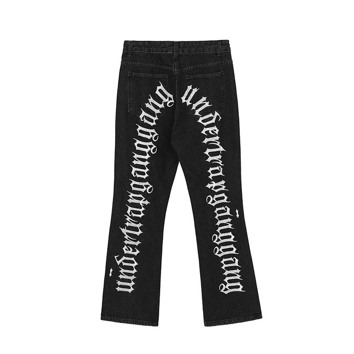 A man wearing Maramalive™ Hip-Hop Trousers with Ripped Black Denim & Lettering Embroidery 