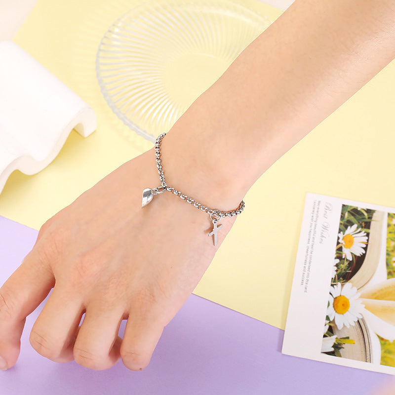 A woman's hand with a Maramalive™ Minimalist Cross Bracelet on it.