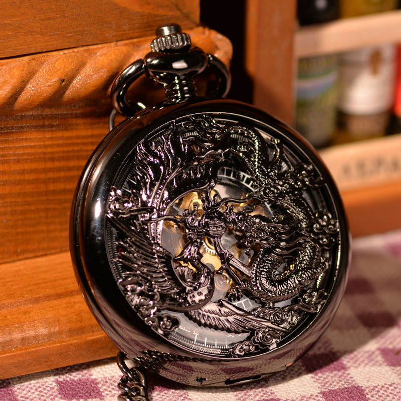A Hollow Dragon And Phoenix Play Beads Pocket Watch by Maramalive™ sitting on a table.