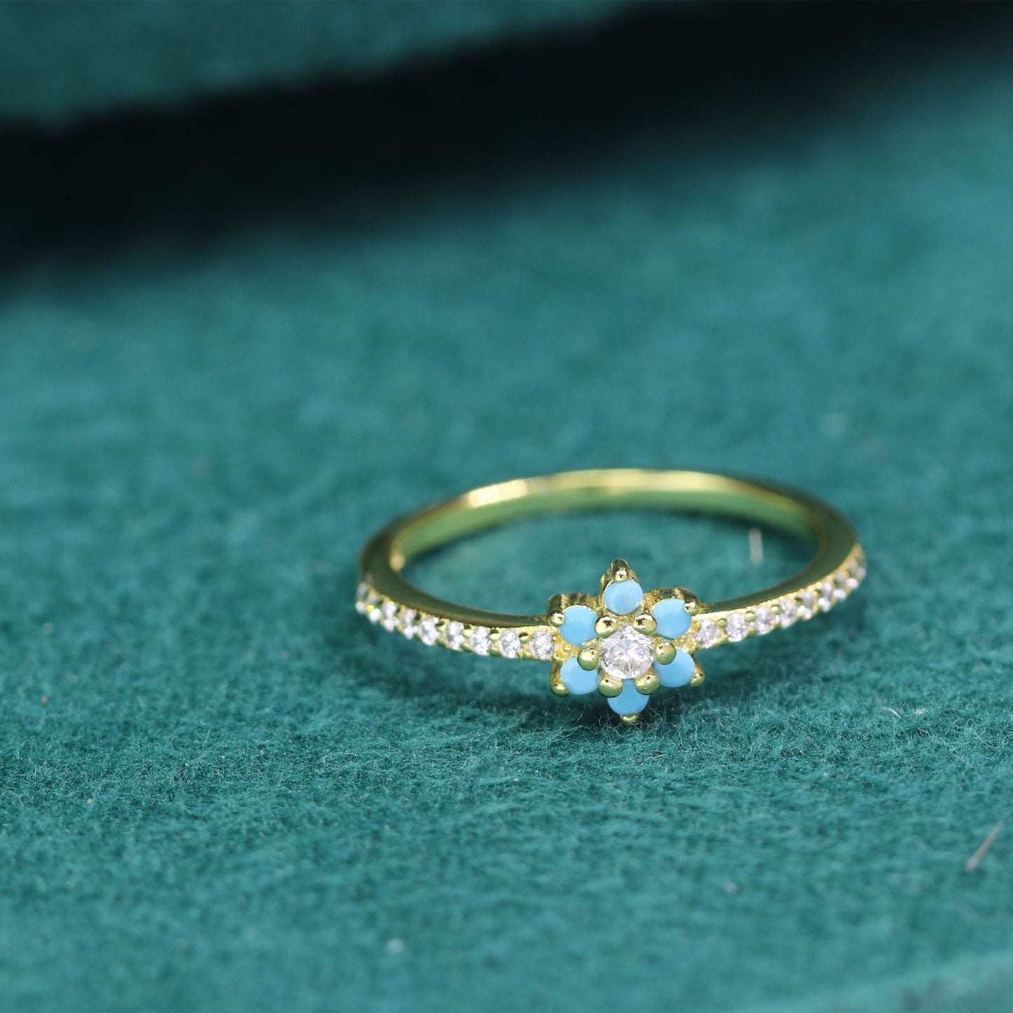 A hand holding a Maramalive™ Women's S925 Silver Simple Little Daisy Flower Ring with diamonds.