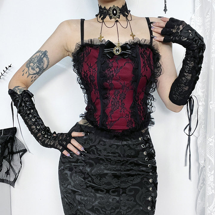 Person wearing a Maramalive™ Dark gothic lace camisole | Dark romantic lace top, a black lace choker, and black lace arm warmers with a floral lace pattern. They have a visible tattoo on their upper arm and are standing against a white backdrop.