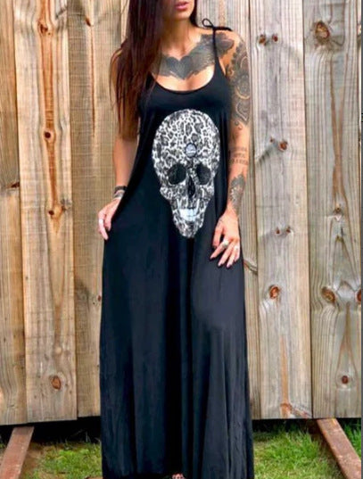 A woman in a ghoulishly glam black dress with a skull print wearing the Maramalive™ Drop Dead Gorgeous - Strap Style Skull Mid-length Print Dress.