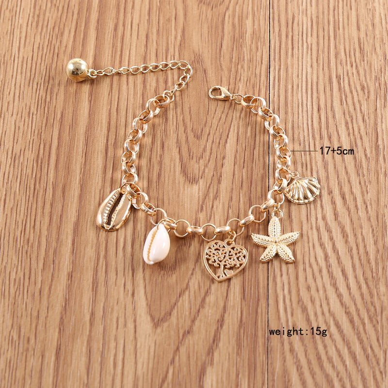 A woman wearing a Maramalive™ Women's Fashion Simple Shell Starfish Scallop Love Bracelet.