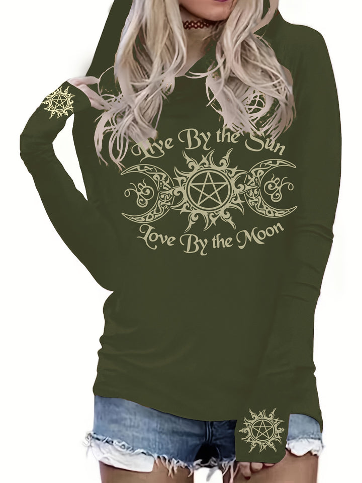 A person wearing a dark green Maramalive™ Gothic Graphic Print Hooded T-shirt, Casual Long Sleeve T-shirt For Spring & Fall, Women's Clothing with the text "Live By the Sun, Love By the Moon" and decorative symbols, paired with denim shorts.
