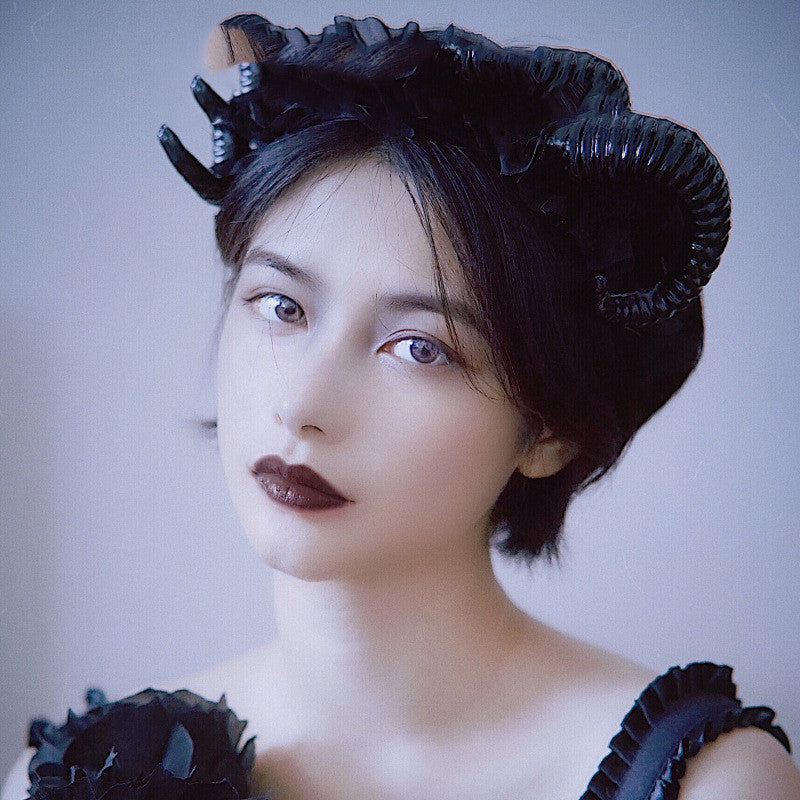 A woman with Maramalive™ Demon Horn Hair Hoop Dark Gothic Photography Props on her head.