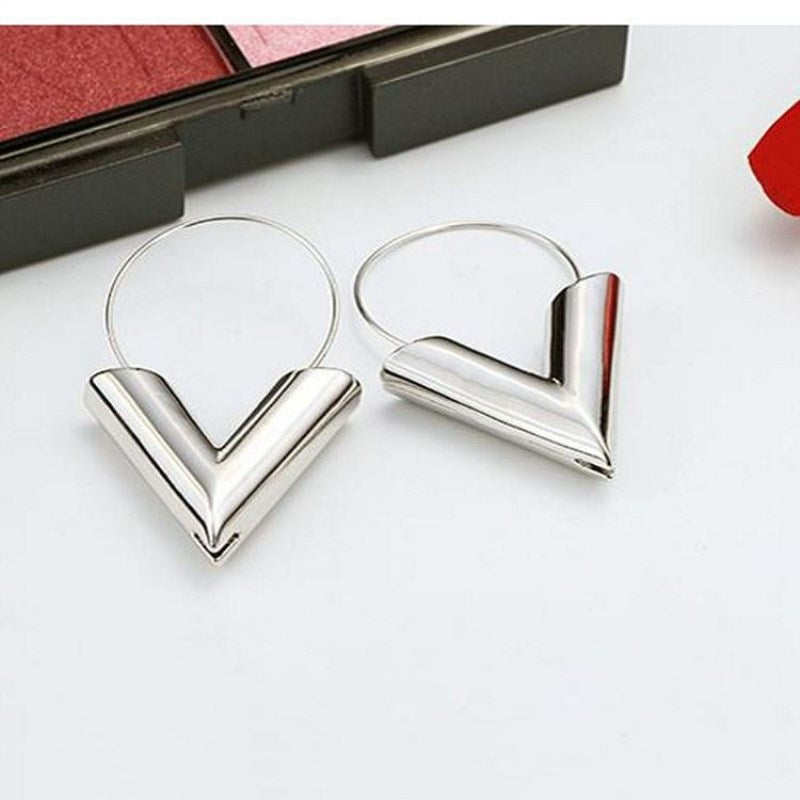 A pair of Minimalist Triangle Earrings from Maramalive™ on a white background.