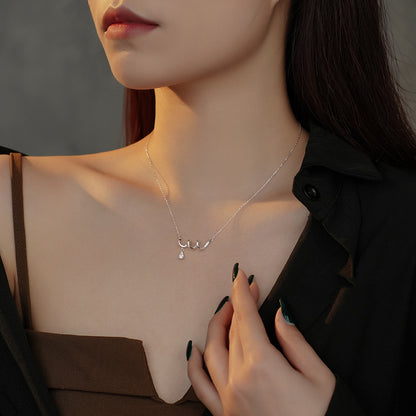 A woman is posing with a Maramalive™ Women's Graceful And Fashionable Sterling Silver Geometric Spiral Zircon Necklace on her chest.
