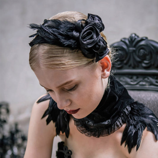 A woman wearing Gothic Flower Hair Clips in a black feathered headband from Spooky Locks Accessories by Maramalive™.