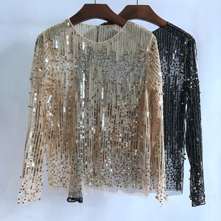 Two Maramalive™ Fashion Bottoming Shirt Sequined Tops For Women are displayed on hangers. One is beige with gold sequins, and the other is black with silver sequins. Both free-size tops feature sheer polyester fiber material and are hanging against a white background.
