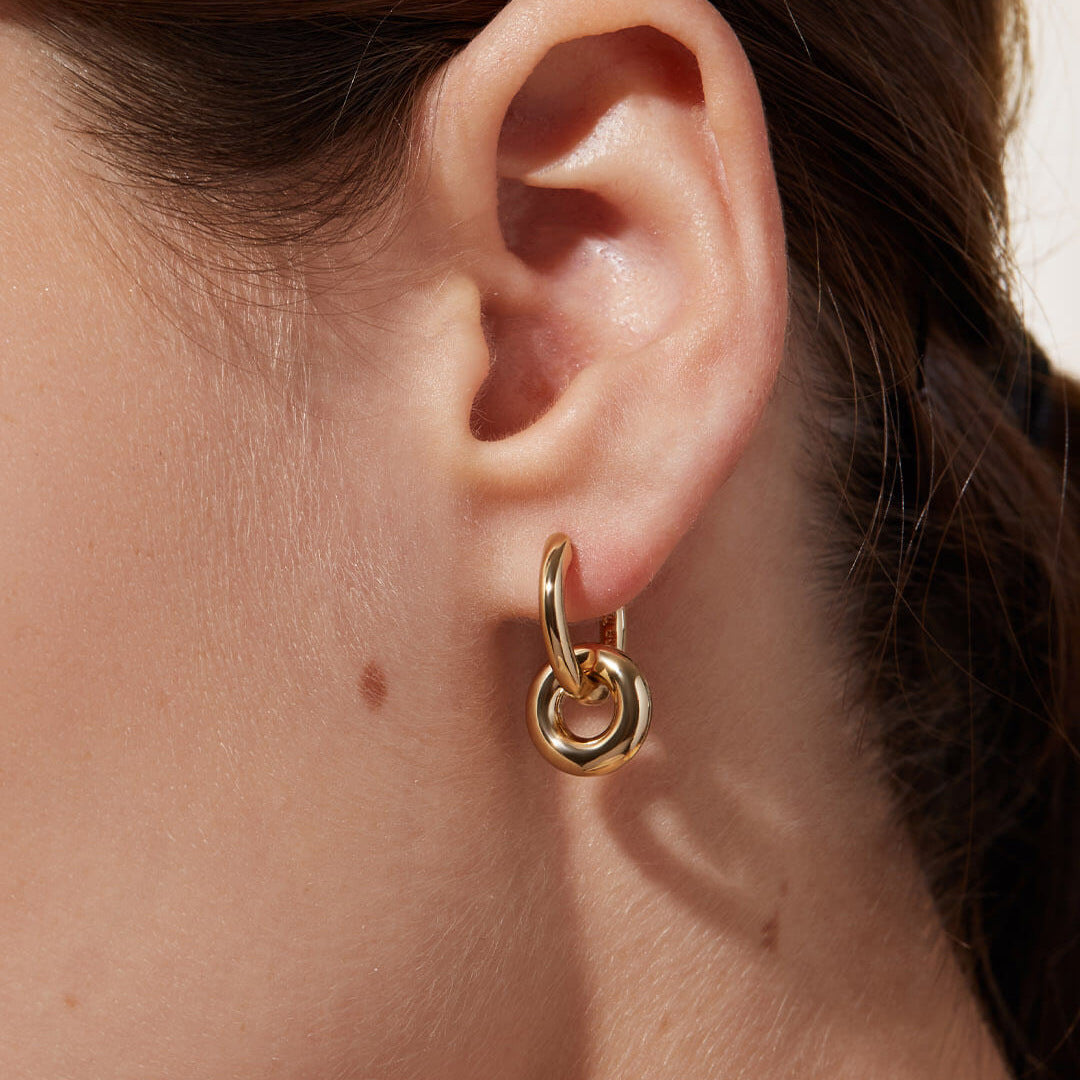 A woman wearing a pair of Maramalive™ Gold Double Hoop Earrings.