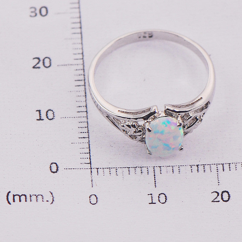 A Maramalive™ white opal ring on a white background.