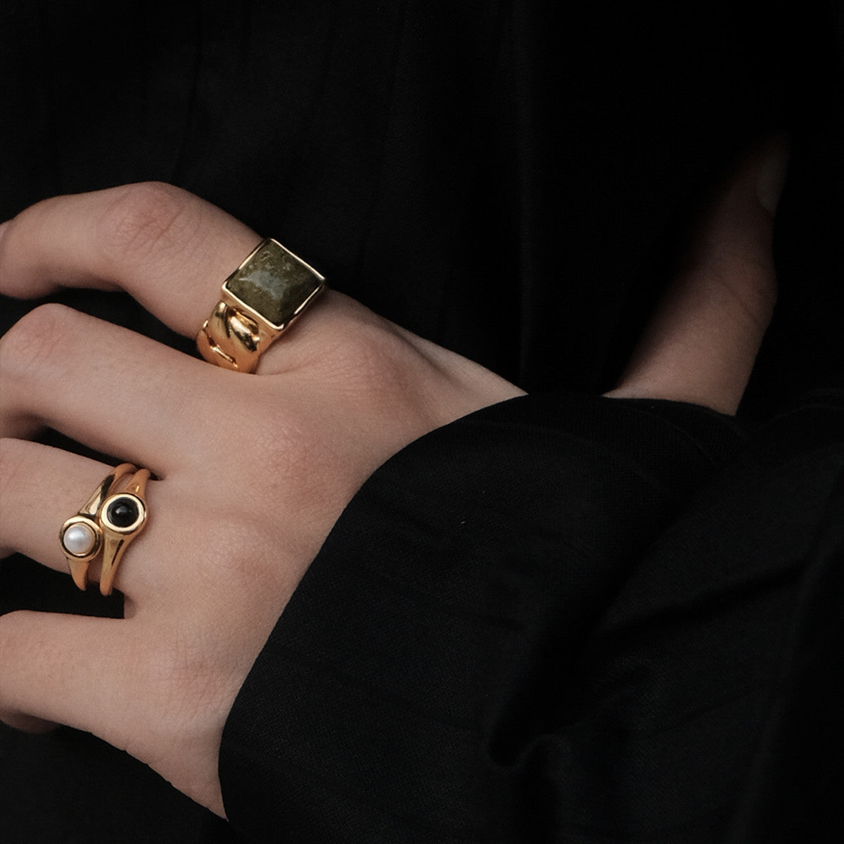 A woman wearing a Maramalive™ European And American All-match Pearl Black Onyx Ring with an evil eye on it.
