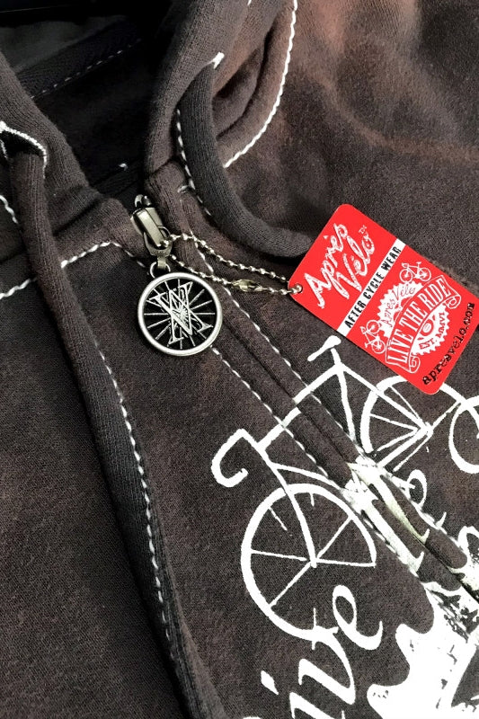 Close-up of a dark Maramalive™ Hooded Sweater Motorcycle Heavy Metal Punk Can Take Lovers featuring white bicycle graphics, a patch-printed zipper, chain with a metal pendant, and a red and white tag labeled "Live to Ride." The loose fit ensures comfort while keeping you in style.
