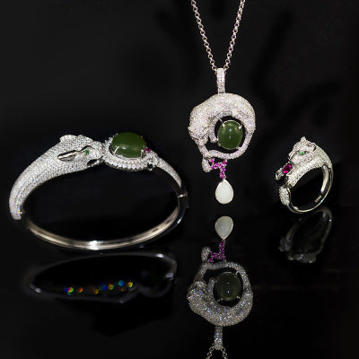 A collection of Maramalive Silver inlaid jade jewelry set on a black surface.