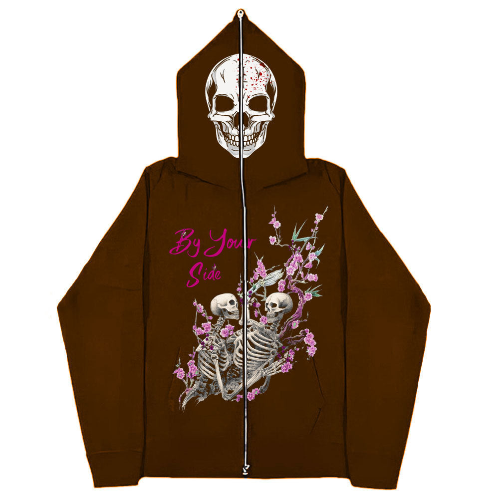 A brown Gothic Zipper Sweater: The Perfect Gothic Top Multi-colors by Maramalive™ featuring a skull on the hood and an illustration of two skeletons surrounded by pink flowers on the back, with the text "By Your Side" in pink script. This Gothic style piece blends edge with elegance effortlessly.