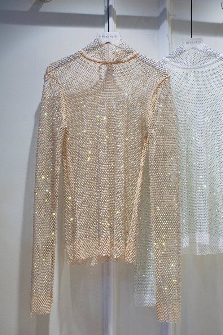 Two Maramalive™ New Crystal Rhinestone Hollow Top Starry Bright Sexy Ladies Long Sleeve See-through Net Diamond Shirts adorned with sparkly embellishments and high collars are displayed on hangers against a light-colored background.