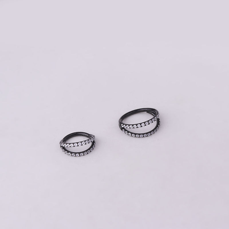 A set of Maramalive™ Stainless Steel Double Row Carved Zircon Seamless Nose Rings on a black surface.