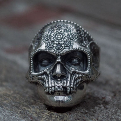 A man's hand is holding a Maramalive™ Discover the Mysteries of the Afterlife with this Striking Sugar Skull Ring.