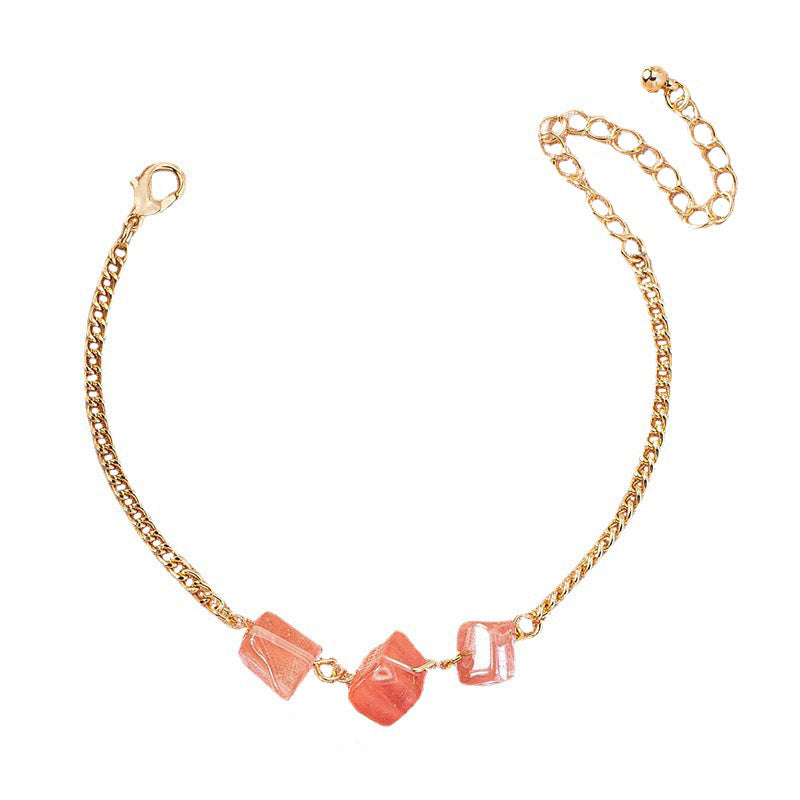 A woman wearing a Maramalive™ Women's Fashion Temperament Irregular Natural Crushed Stone Bracelet with a pink stone.