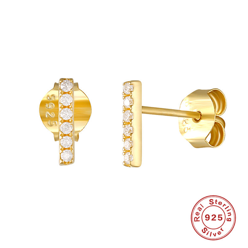 A woman's ear with a Maramalive™ S925 Sterling Silver Single Row Ball Stud Earrings White Gold Color.