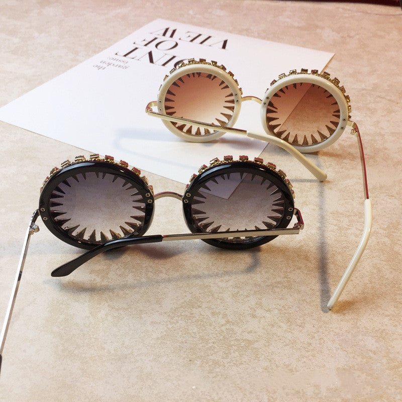 A pair of Maramalive™ Ralferty Unique Round Rivet Steampunk Sunglasses Women Men with a metal frame.