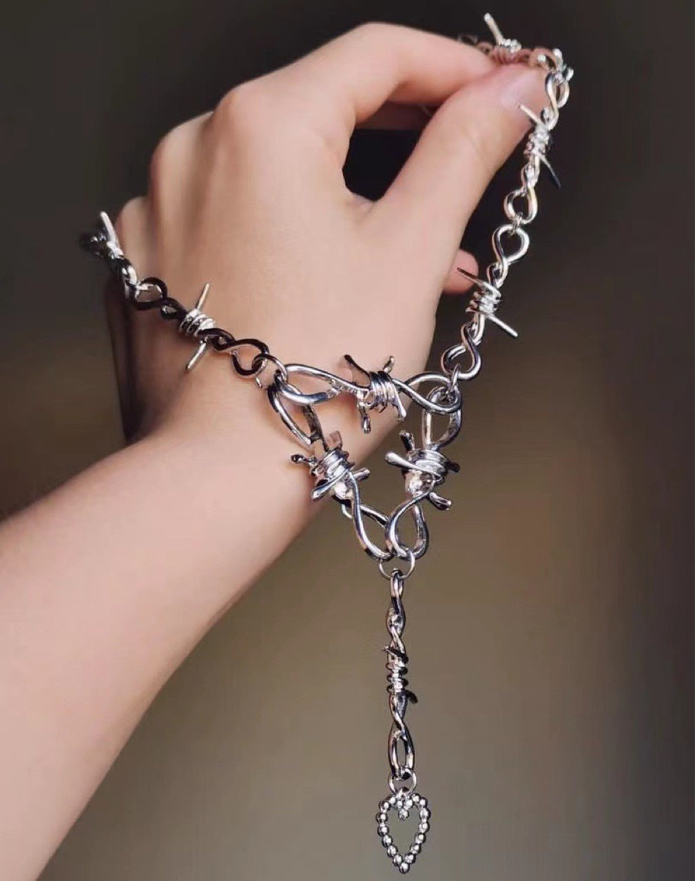 Love Heart Thorns Vintage Necklace | Barbed Wire Statement Necklace on a hand model