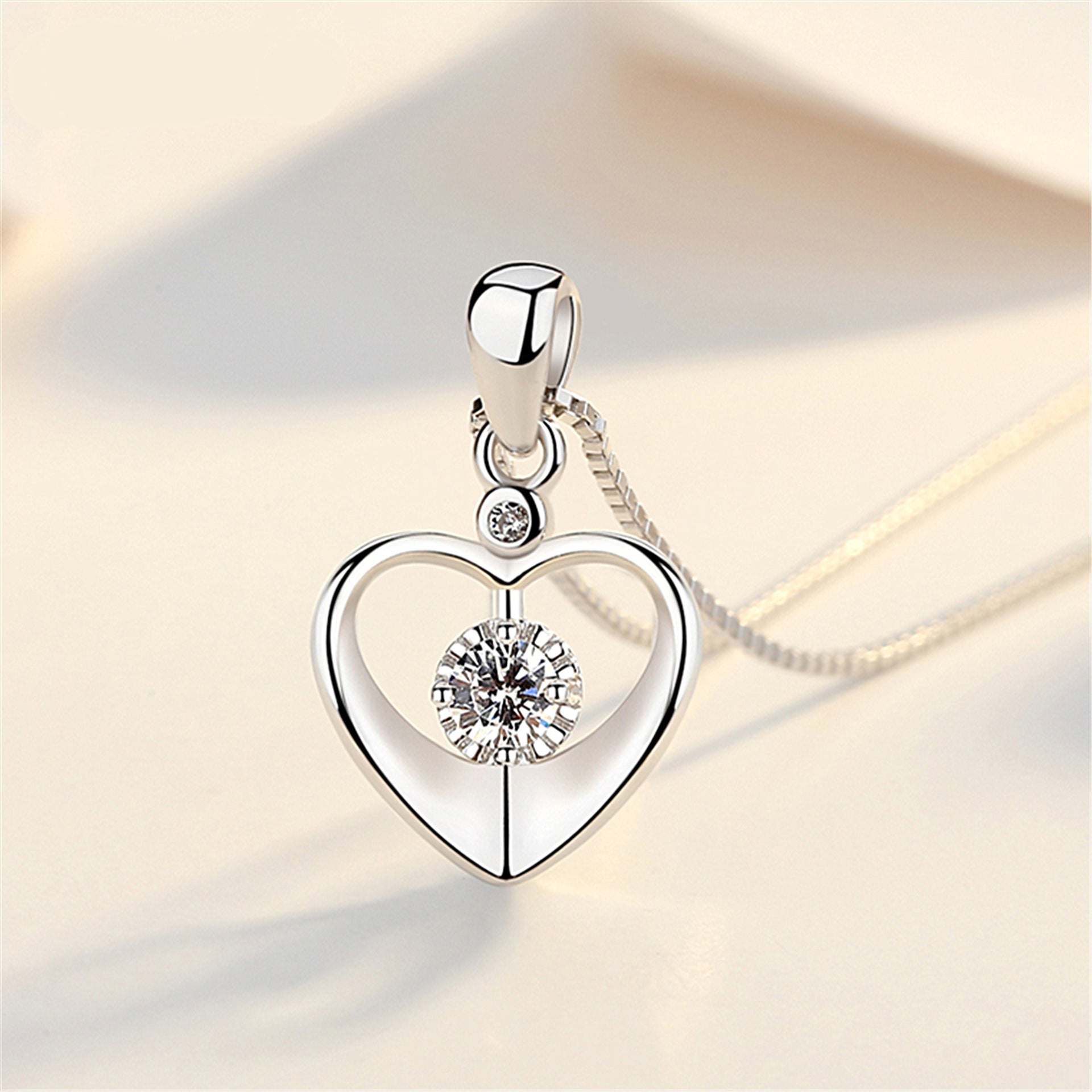 A Maramalive™ Heart Pendant Necklace Simple Couple Clavicle Chain with a diamond in the center.