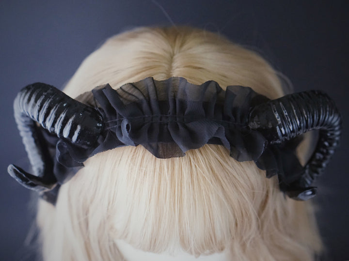 A woman with Maramalive™ Demon Horn Hair Hoop Dark Gothic Photography Props on her head.