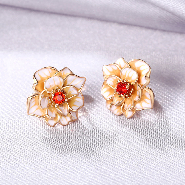 A pair of Maramalive™ Minimalist Earrings with red stones.