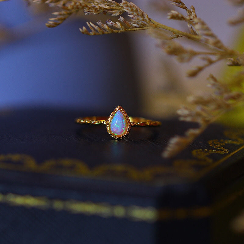 A Women's Fashion Vintage Opal Ring from Maramalive™ sitting on top of a box.