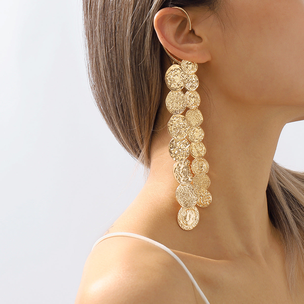 A woman wearing a pair of Maramalive™ Alloy Multi Layer Circle Earrings.