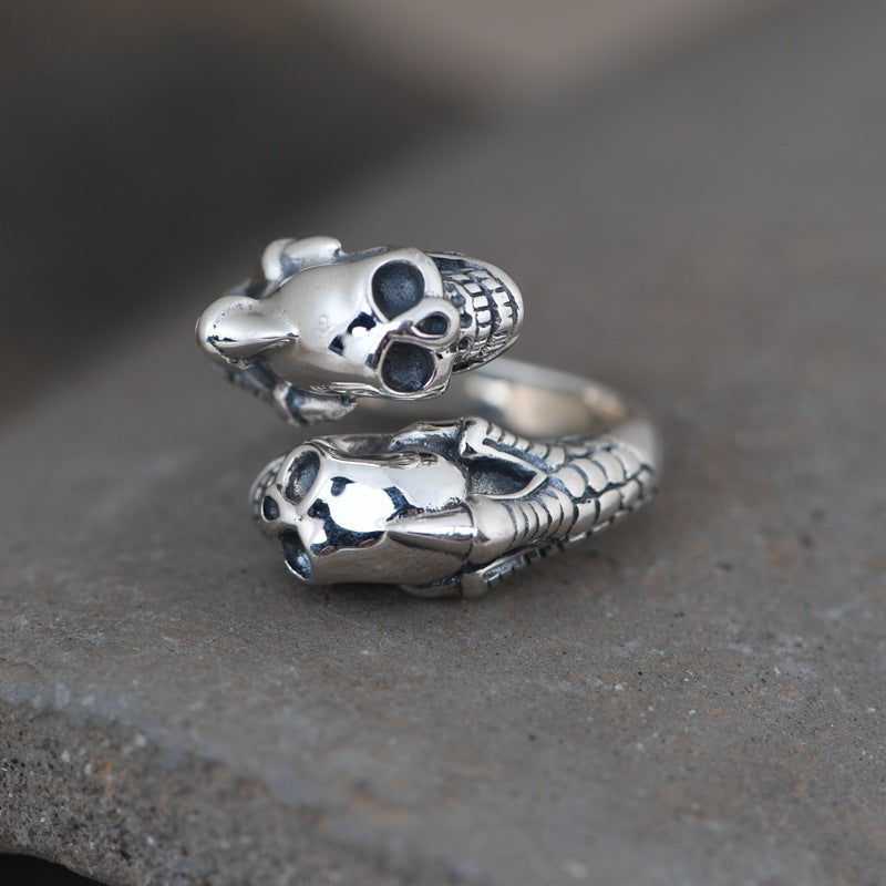 A person is holding a Retro Skull Adjustable Silver Ring with a skull on it from Maramalive™.