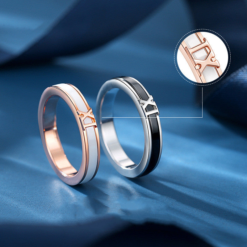 Two Maramalive™ Men's And Women's Fashion All-matching Silver Electroplated Couple Rings with roman numerals on top of a blue surface.