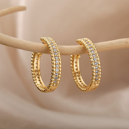 A pair of Zircon Micropaved Earrings by Maramalive™ with diamonds.