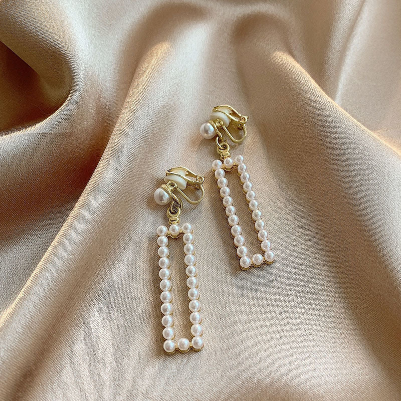 A woman wearing Maramalive™ Pearl Clip-on Earrings.