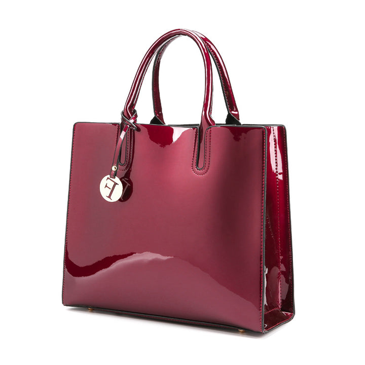 A burgundy patent tote bag with a metal handle, made from high-quality leather was replaced to:
A burgundy Maramalive™ patent shoulder cross-body bag with a metal handle, made from high-quality mirrored leather.