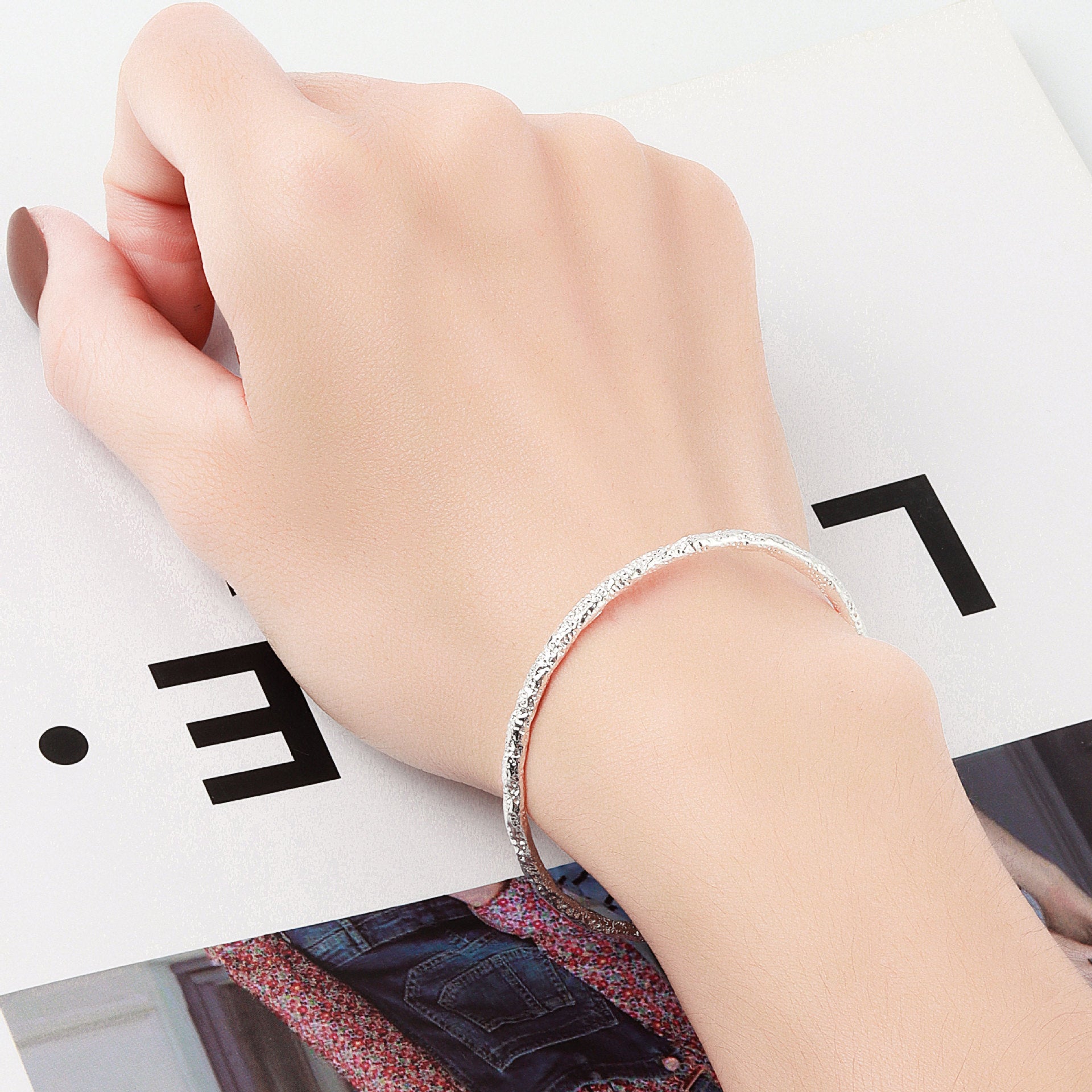 A woman's hand holding a Maramalive™ Women's Fashion Simple And Irregular Bracelet.