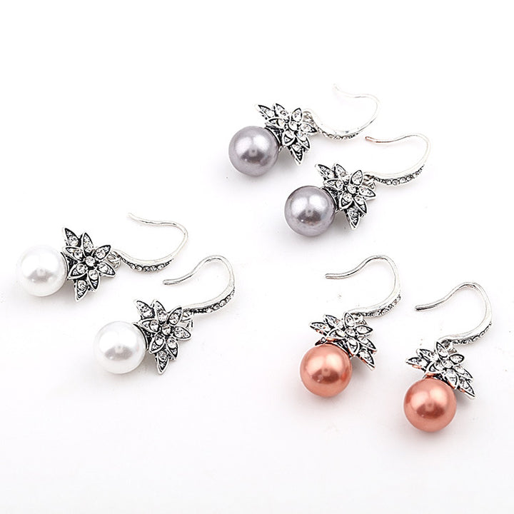 A pair of Maramalive™ gray pearl earrings on a white background.