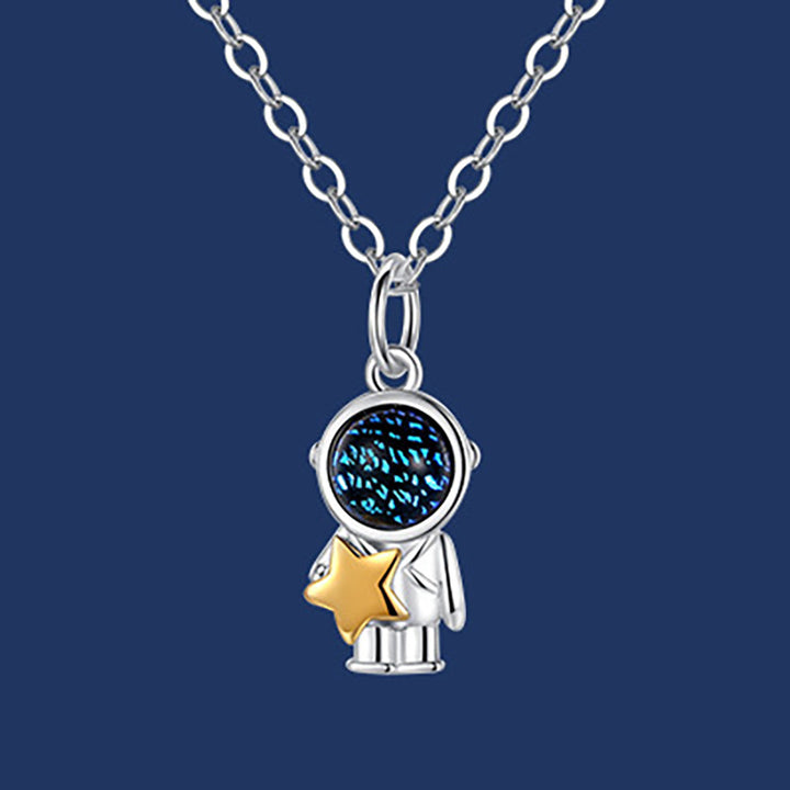 Two people holding hands and holding a Fashionable Spaceman Pendant Necklace from Maramalive™.