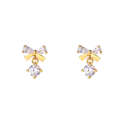 A woman wearing a white shirt and a pair of Maramalive™ Women's Graceful And Fashionable Pure Silver Zircon Bow Stud Earrings.