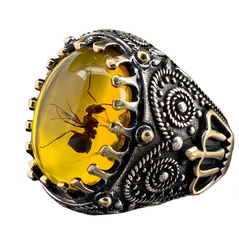 A Retro Two-color Men's Black Agate Ring with a yellow amber stone.