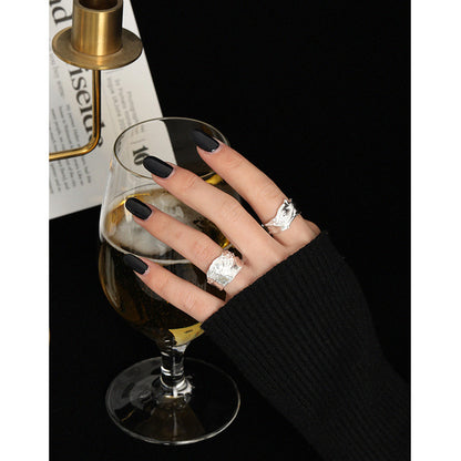 A woman's hand holding a glass of wine and a Maramalive™ Texture Ring.