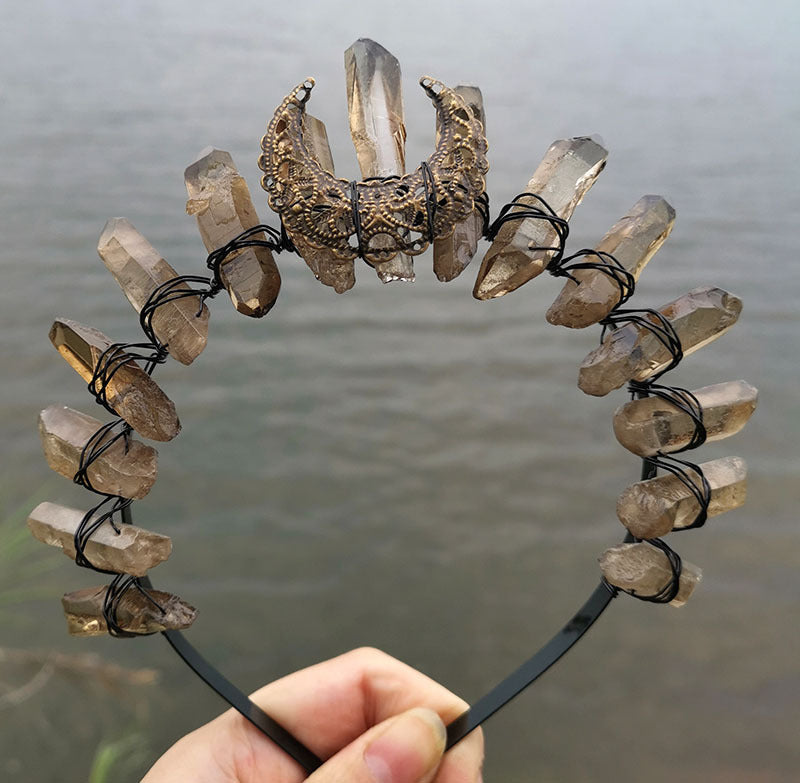 A person holding a Crystal Witch Headband with crystals on it. (Brand Name: Maramalive™)