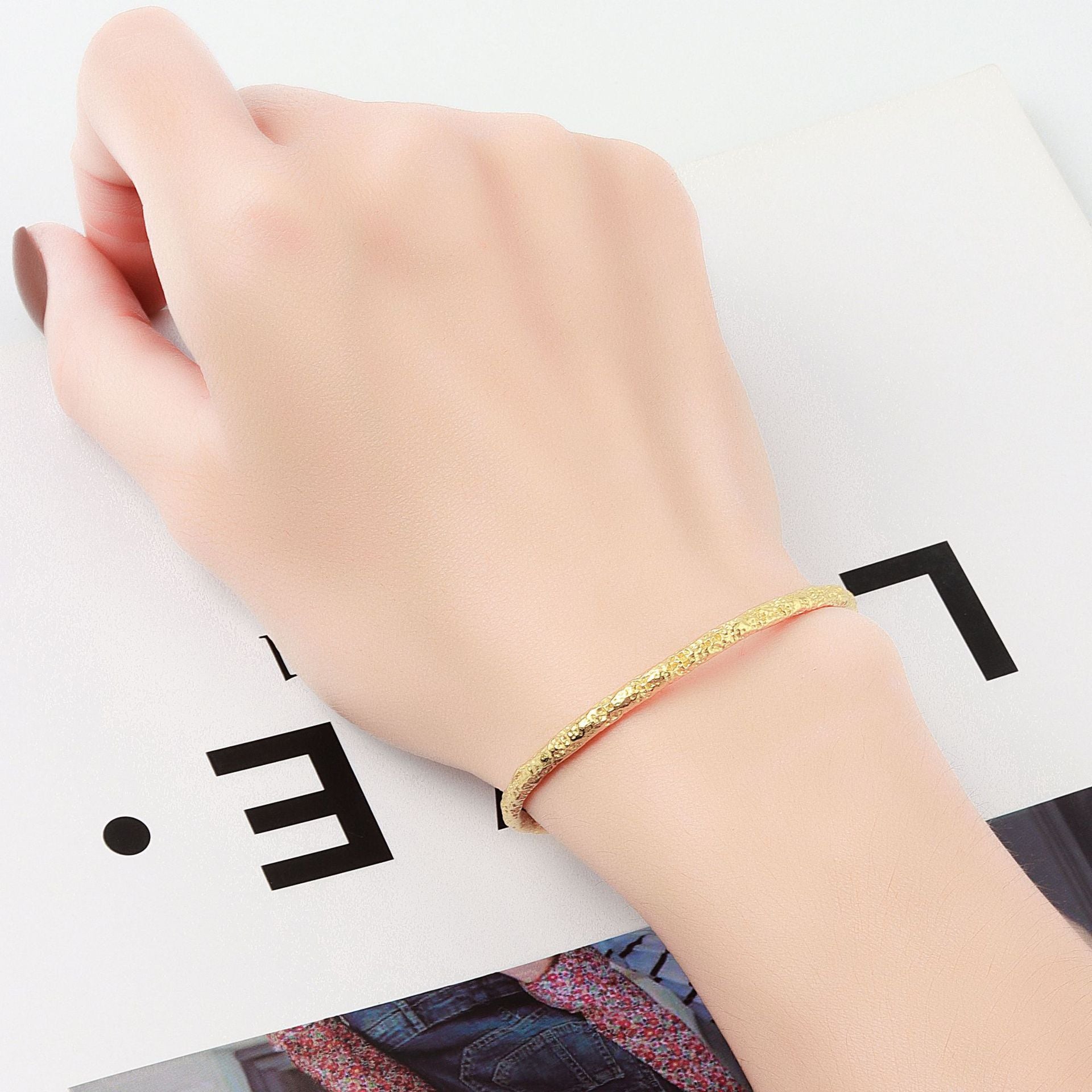 A woman's hand holding a Maramalive™ Women's Fashion Simple And Irregular Bracelet.