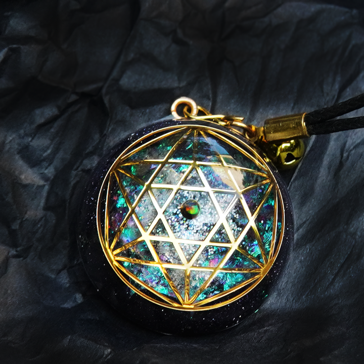 A Maramalive™ black and gold pendant with a Geometric Totem Om Yoga Crystal Necklace on it.