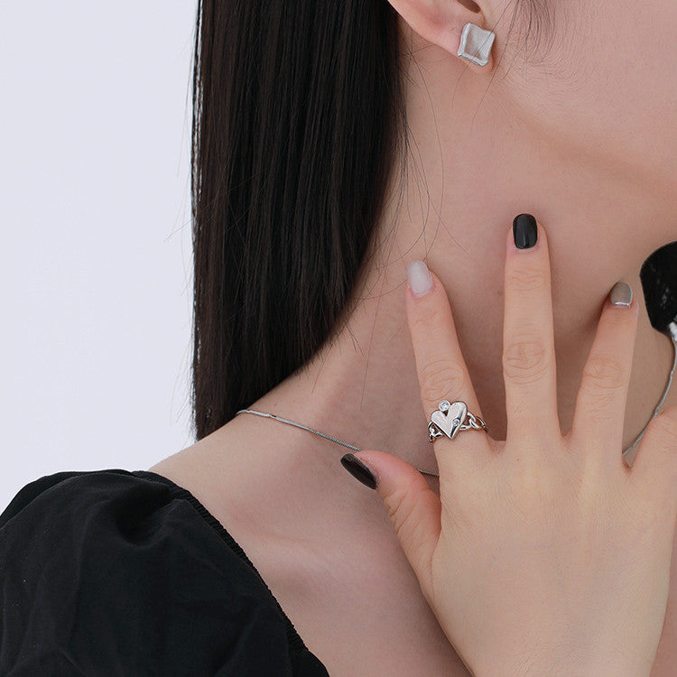 A woman with black nails and a Pretty, thoughtful Gift for Her - Women's Fashion Personality Love Heart-shaped Ring from Maramalive™ on her hand.