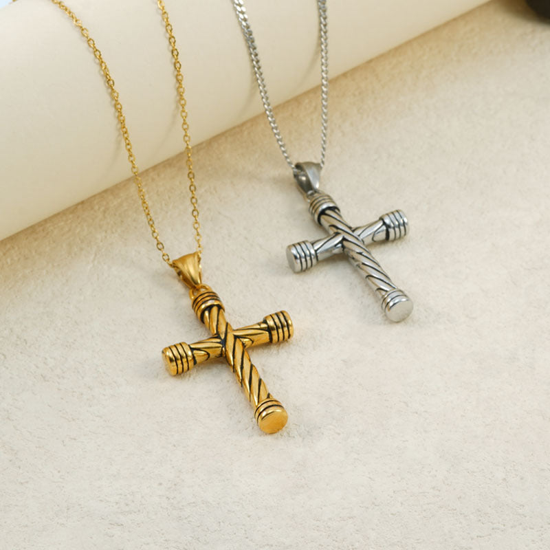 Statement Maramalive™ vintage cross necklaces in gold and silver on top of a clear glass.