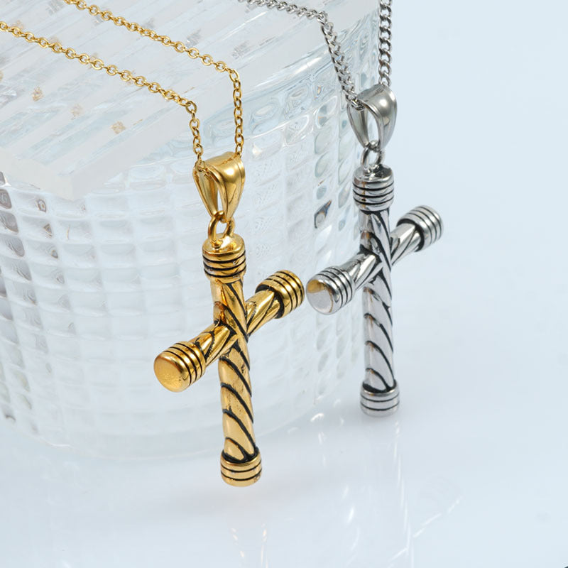 Statement Maramalive™ vintage cross necklaces in gold and silver on top of a clear glass.